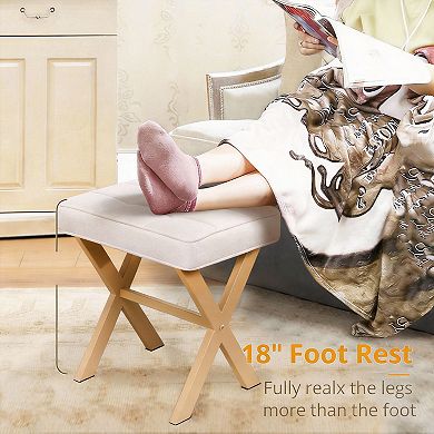 A compact stool with a padded seat and a metal X-shaped base; a vanity stool.