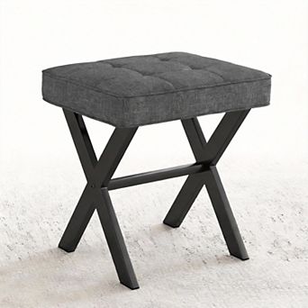 A compact stool with a padded seat and a metal X-shaped base; a vanity stool.