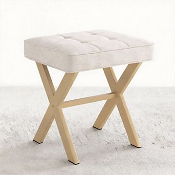 A compact stool with a padded seat and a metal X-shaped base; a vanity stool.