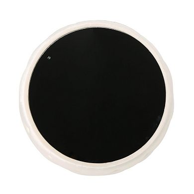 Modern round coffee table with velvet cushions and a tempered glass top