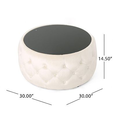 Modern round coffee table with velvet cushions and a tempered glass top