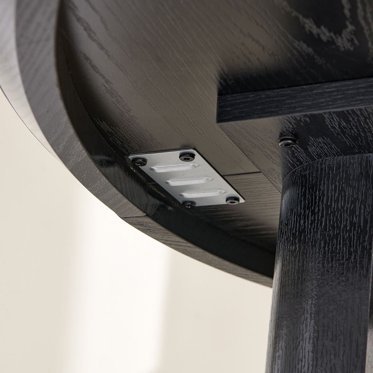 Close-up of hardware bracket under round dining table