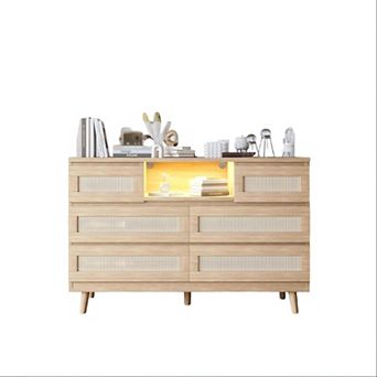 6-drawer rattan dresser features LED light, charging station & TV stand function.