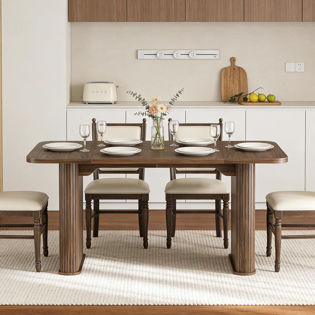 Modern dining table with dark wood tabletop and fluted pedestal legs in a kitchen