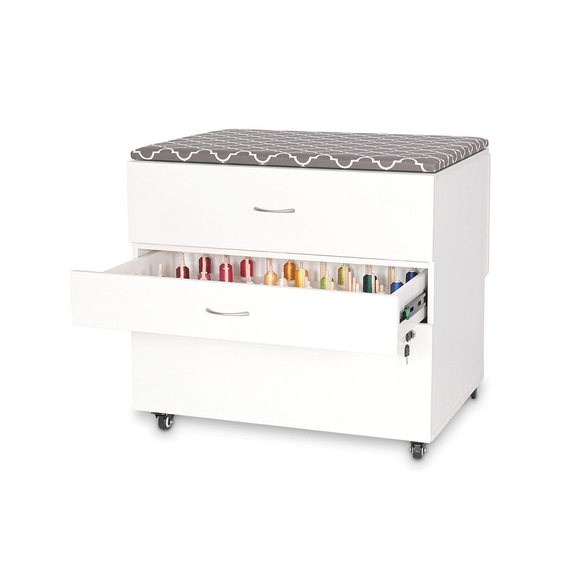 White embroidery storage cabinet with drawer open revealing thread spools