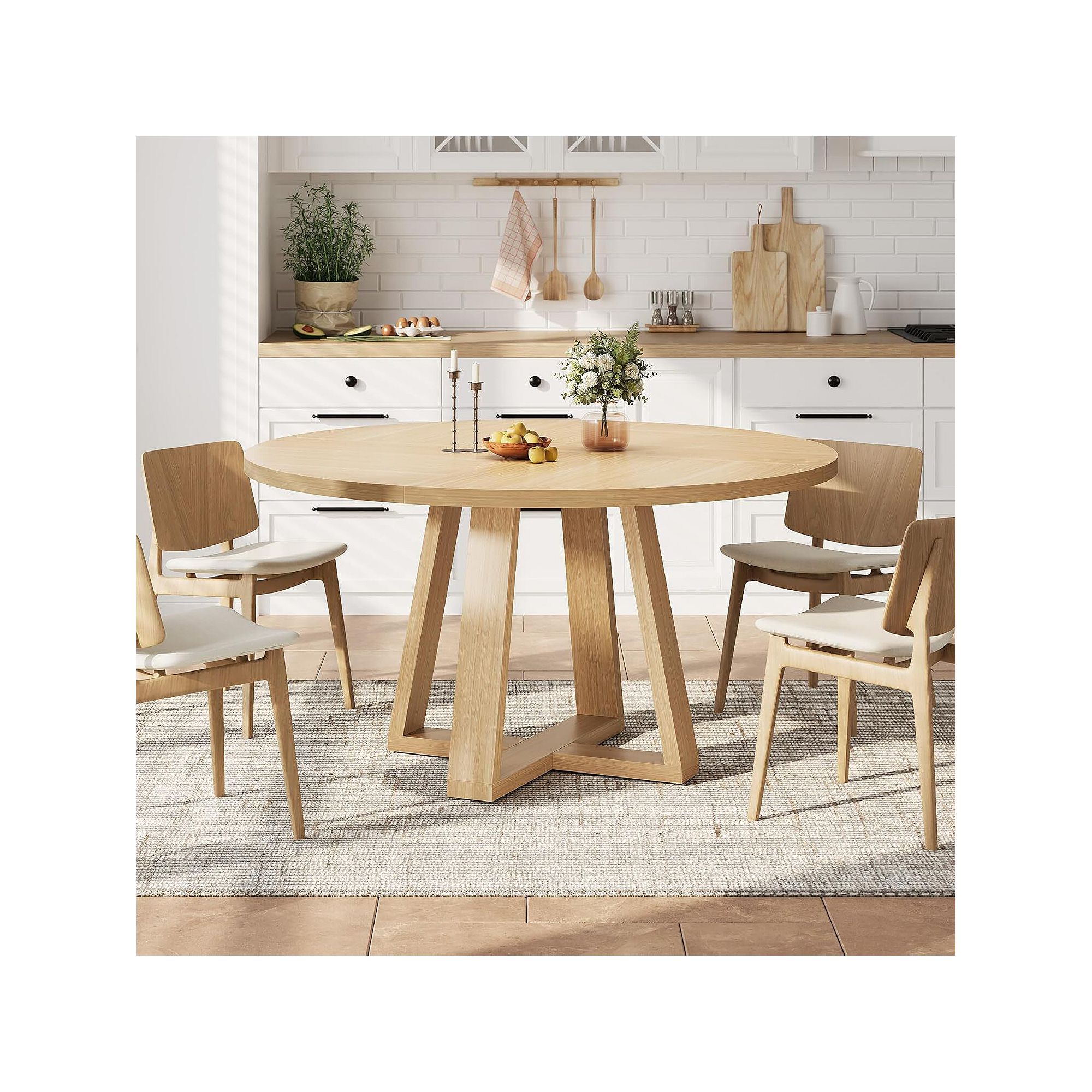 Light wood round dining table with cross pedestal base in dining setting