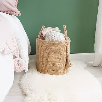 A woven rope storage basket with a handle, suitable for storing blankets, toys, and clothes.