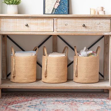 A woven rope storage basket with a handle, suitable for storing blankets, toys, and clothes.