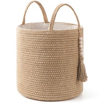 A woven rope storage basket with a handle, suitable for storing blankets, toys, and clothes.