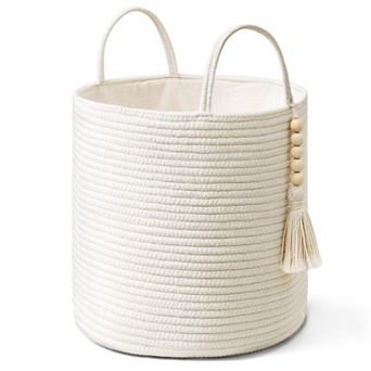 A woven rope storage basket with a handle, suitable for storing blankets, toys, and clothes.
