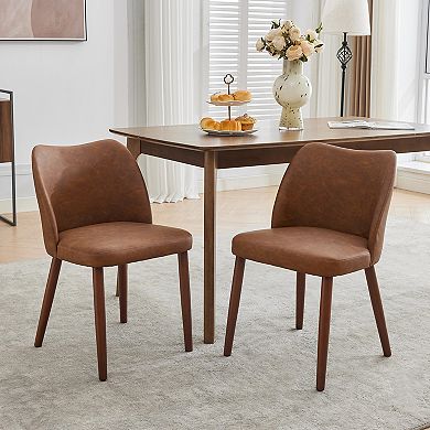 Set of 2 upholstered dining chairs with PU leather upholstery and wooden legs.