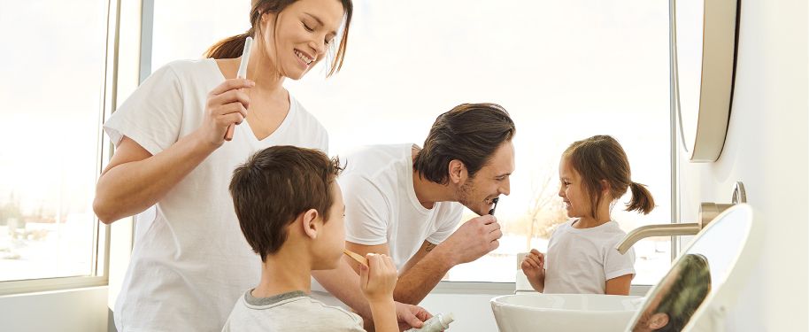 Family brushing teeth together.