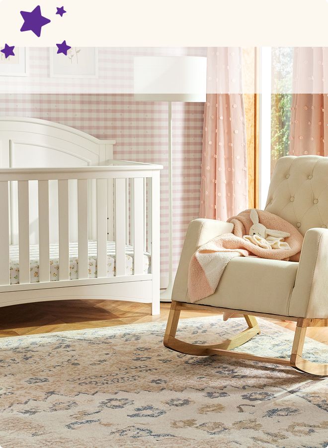 Room with crib, soft colored blanket on chair