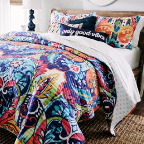 Colorful comforter and pillows on large bed
