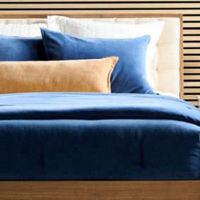 Navy blue bedding with beige pillow