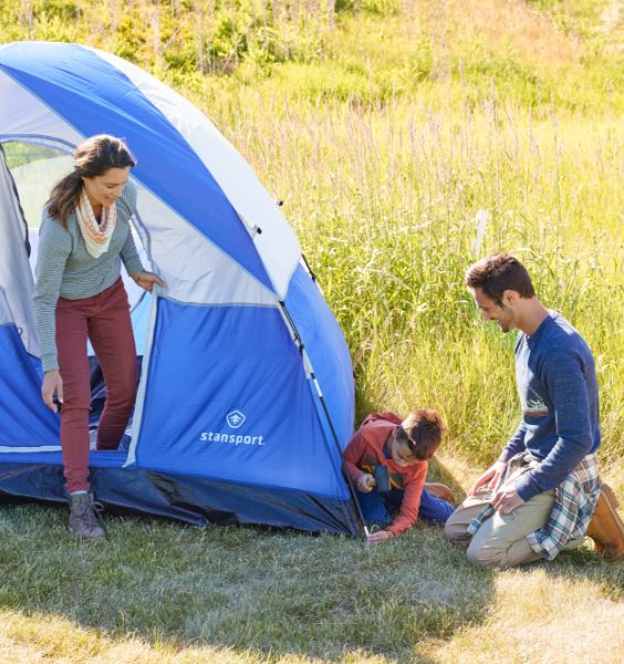 Family setting up camping tent