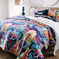 Colorful comforter and pillows on large bed