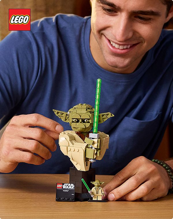 Man assembling Lego Yoga figurine