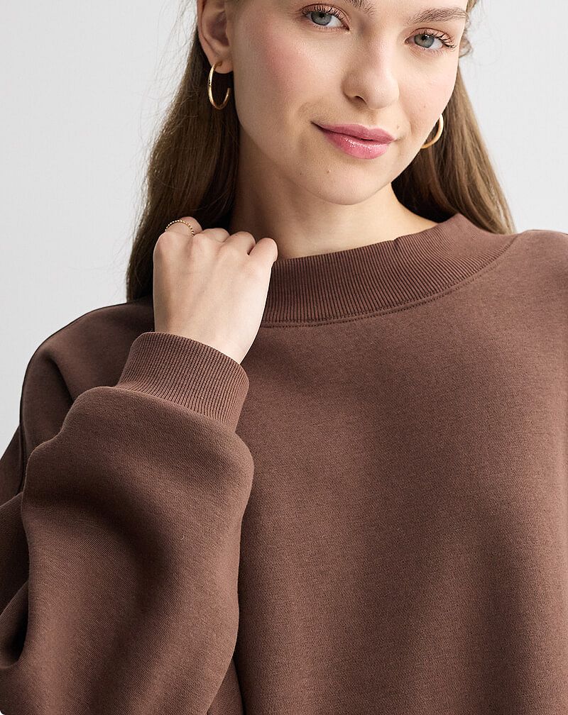 Woman in brown mockneck sweater