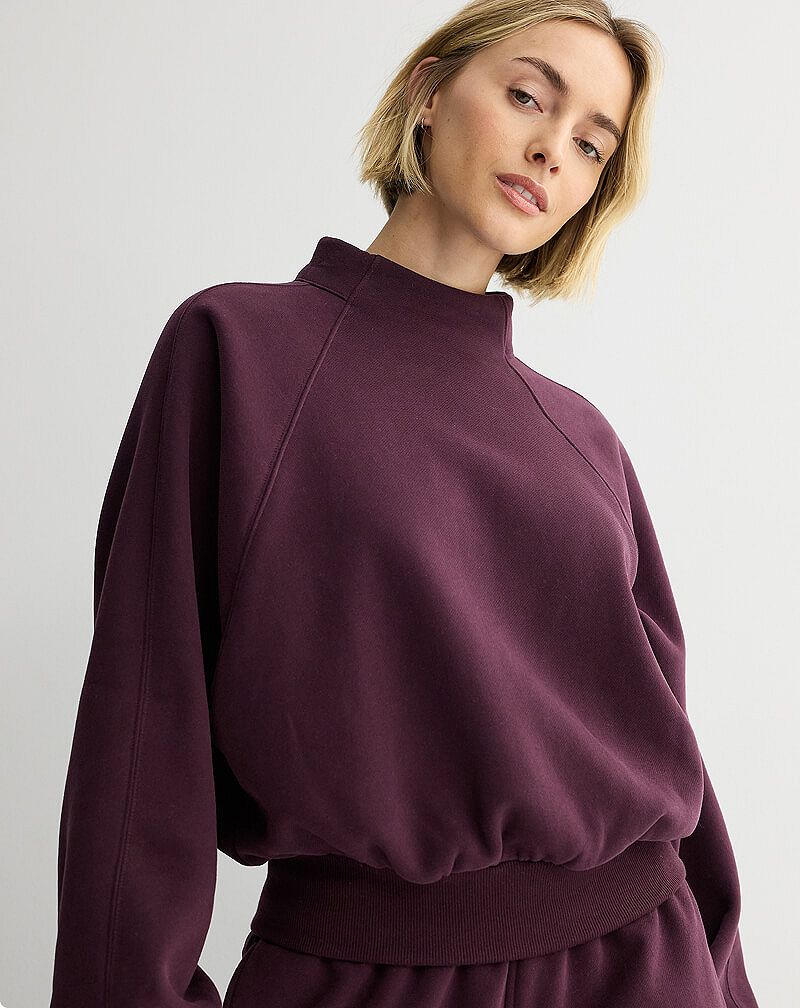 Woman in brown mockneck sweater